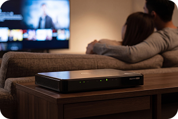 Fanless QNAP HS-264 NAS quietly placed in a living room media cabinet